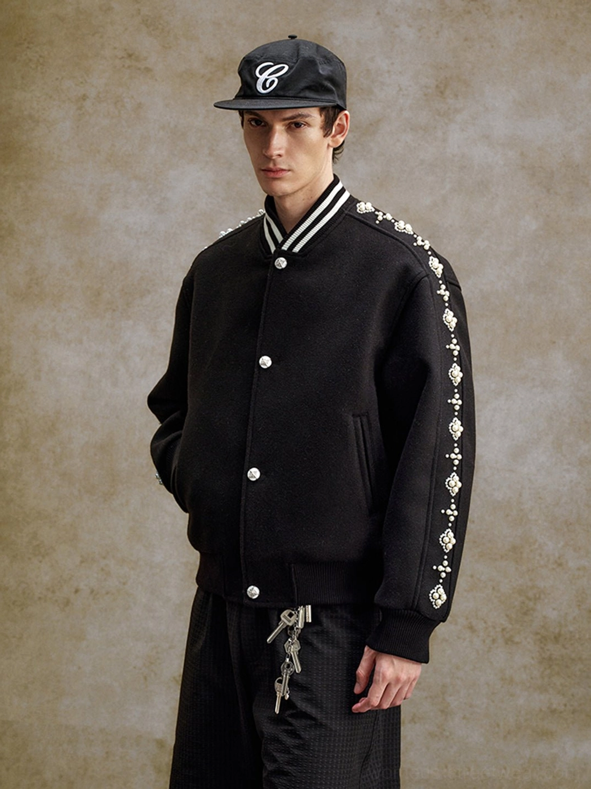 Black pearl beaded varsity jacket with quilted streetwear styling and embellished baseball jacket details
