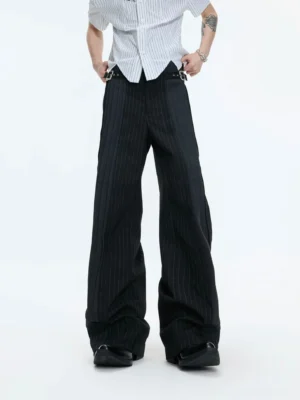 Black pinstripe buckle waist wide leg streetwear pants styled with a striped shirt and black leather shoes in a low angle full body view