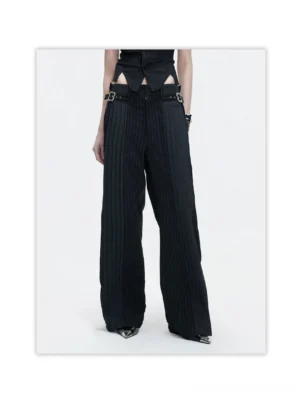 Black pinstripe wide leg trousers with silver buckle waist details styled with a cropped vest and pointed leather shoes