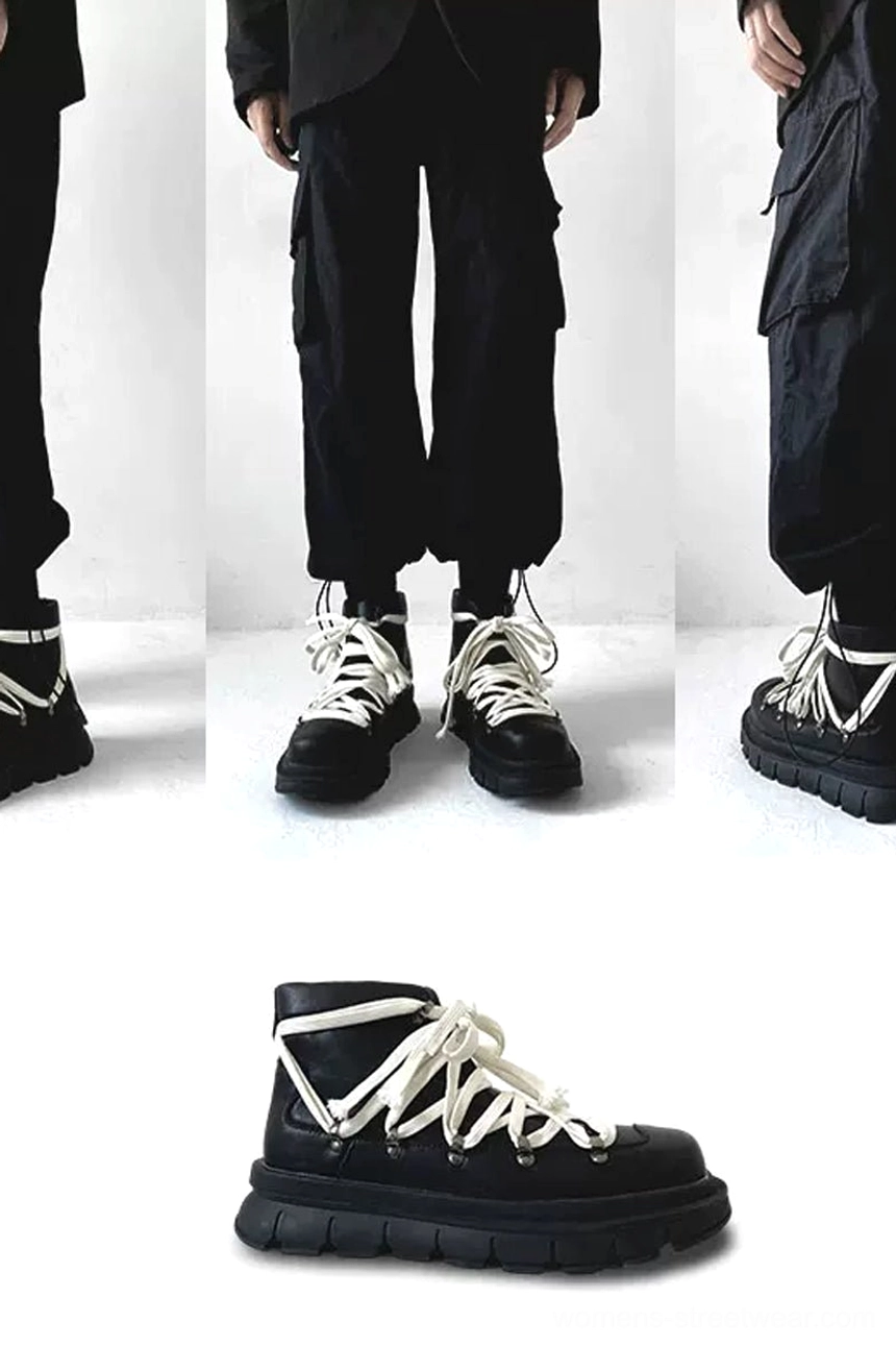 Black platform combat boot worn with minimal all-black streetwear and slim trousers, highlighting the clean upper and chunky hiking-inspired sole