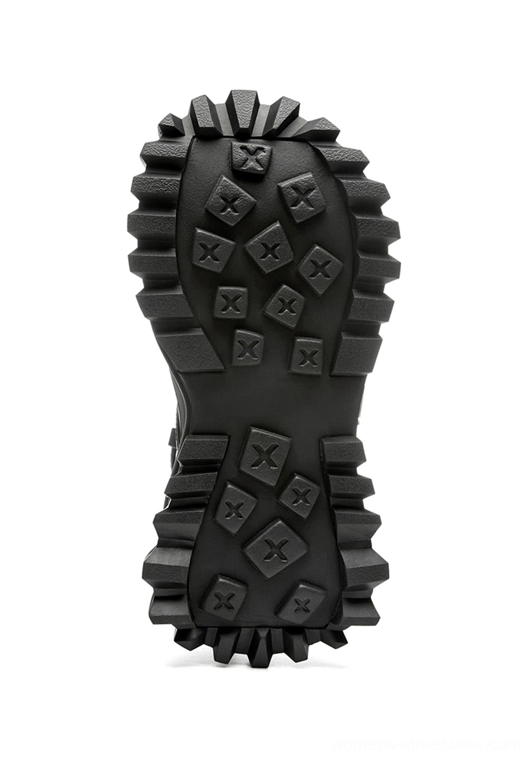 Close-up of black platform combat boot outsole showing rugged deep-lug tread pattern and durable compound sole