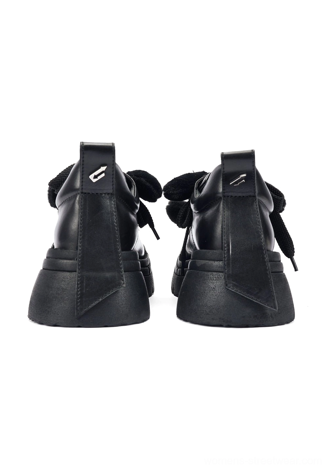 Rear view of black platform derby shoes showing structured EVA outsole, neat stitching, and metal logo detail on the heel pull tabs