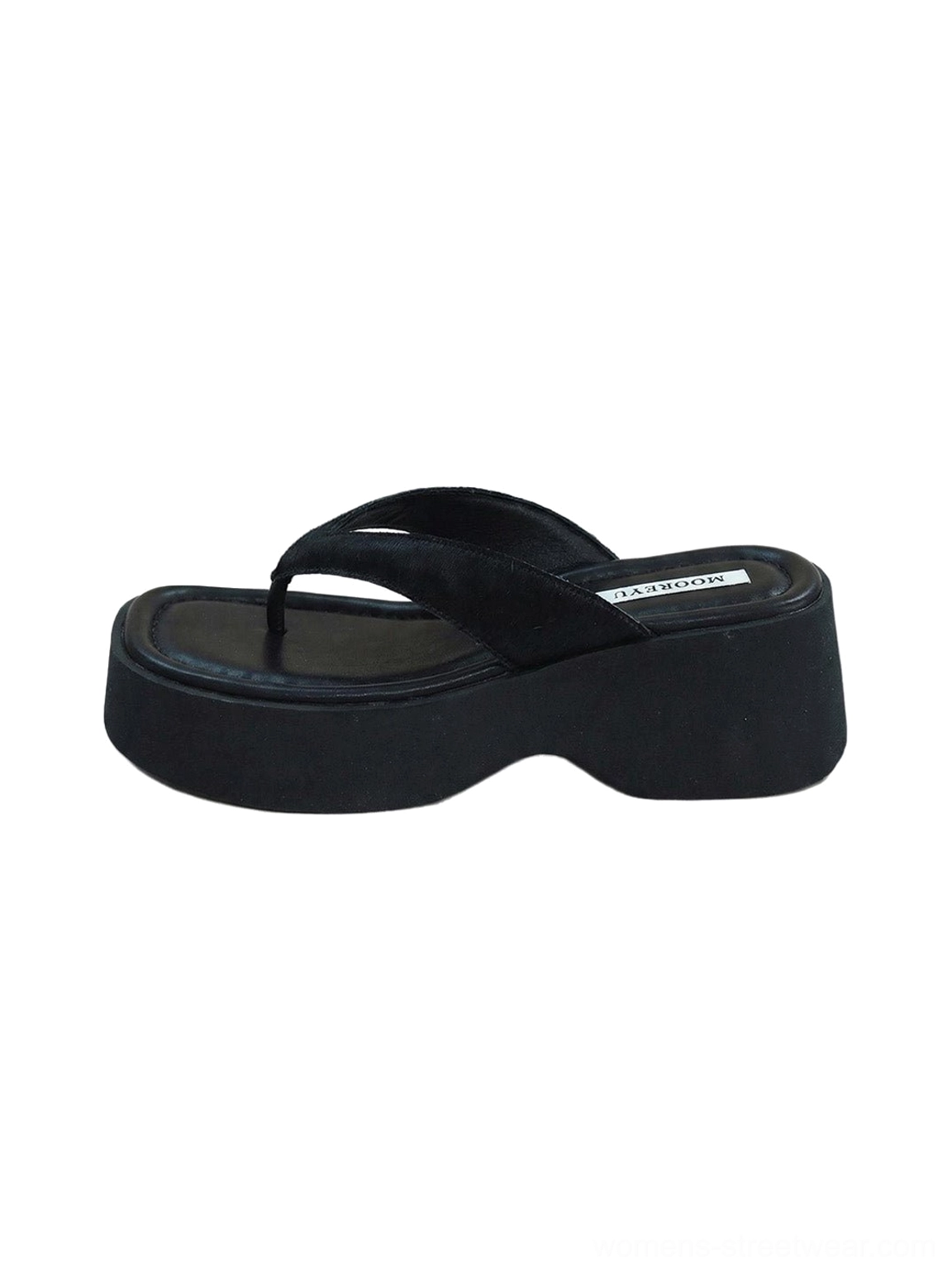 Black platform flip-flops with bold suede thong strap and elevated everyday streetwear profile