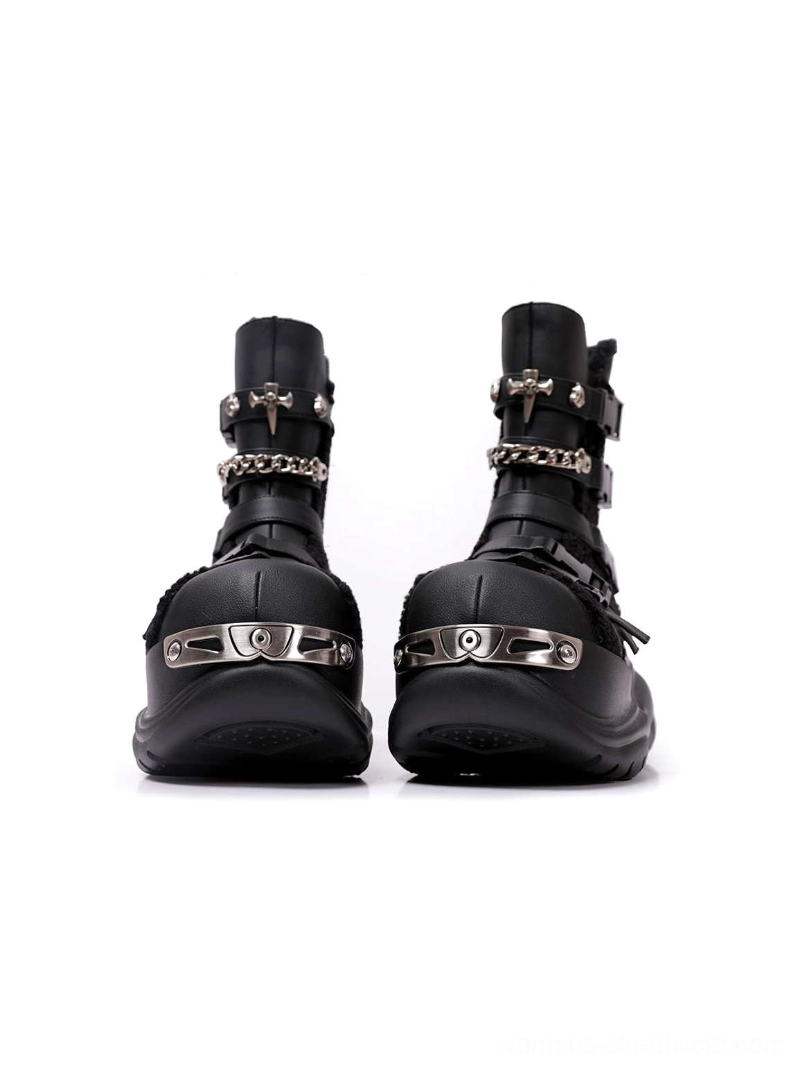 Ultra-close view of black platform motorcycle boot hardware showing metallic buckles, toe cap accents, textured upper, and streamlined sole