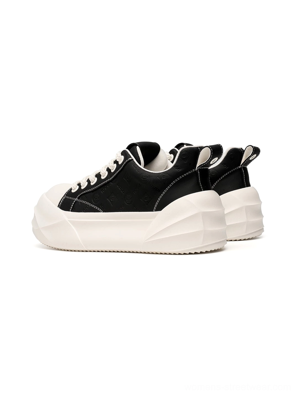 Back view of black low top platform skate sneakers with thick geometric white sole
