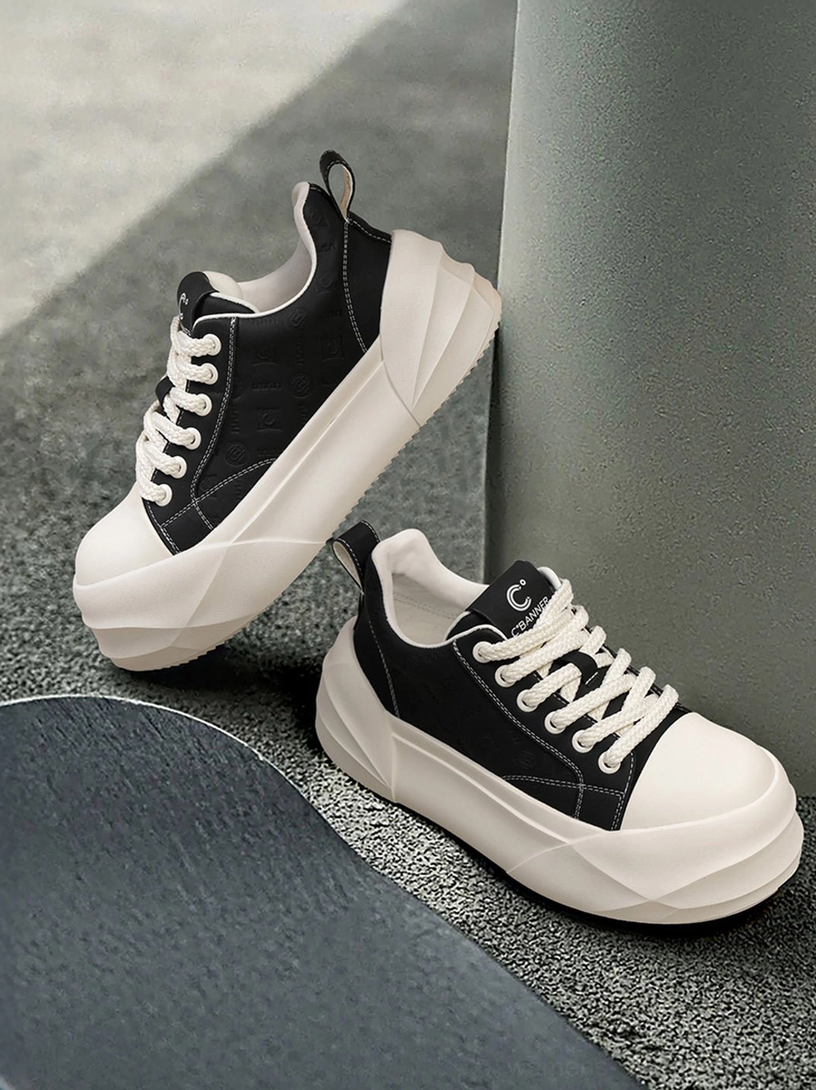 Black lace up platform skate sneakers with oversized geometric white rubber sole product view