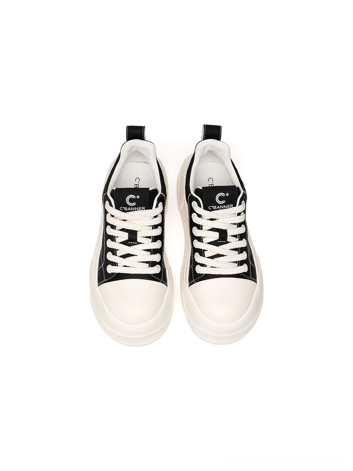 Black low top platform skate sneakers with oversized geometric white sole detail