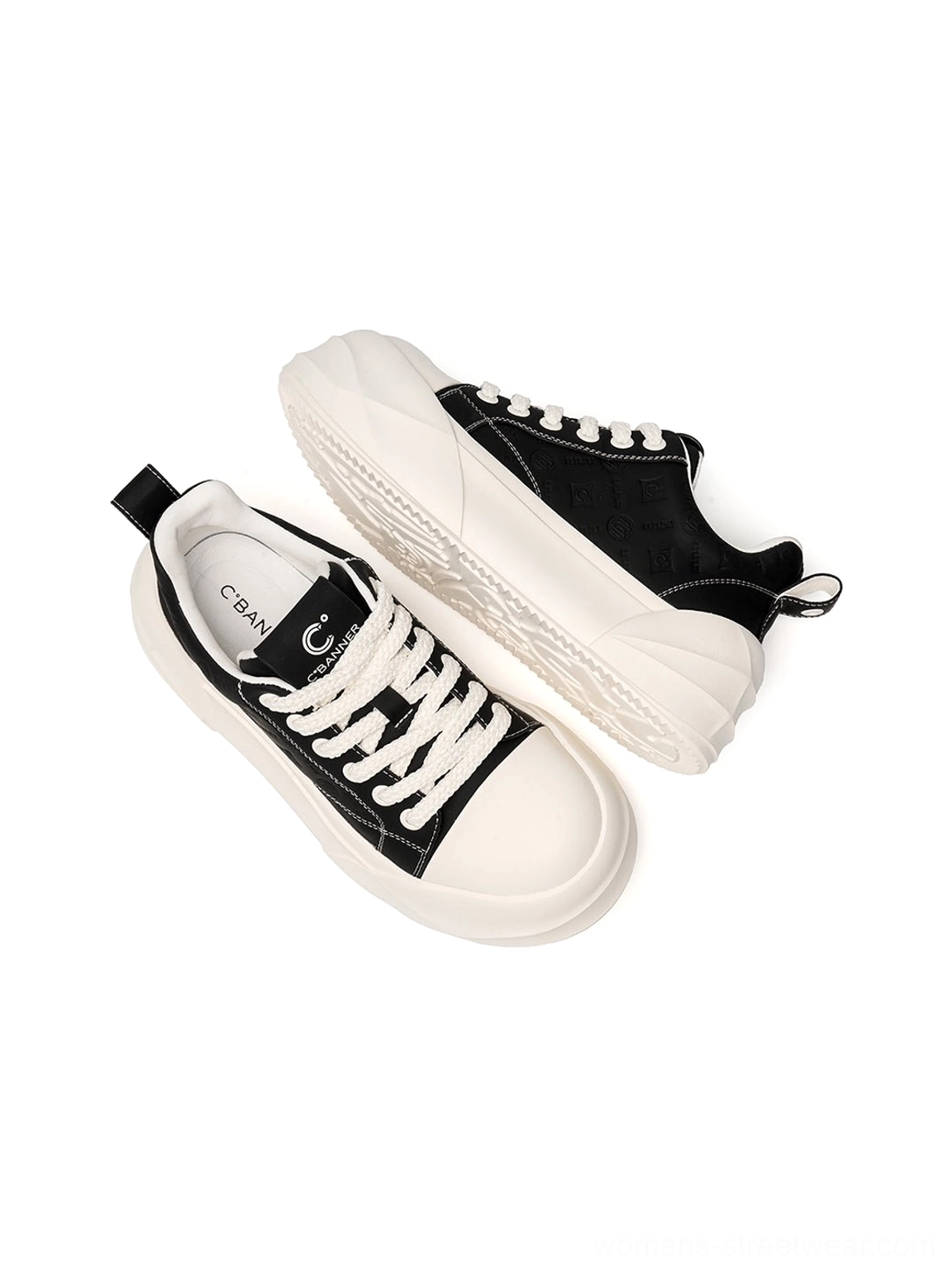 Rear side view of black platform skate sneakers highlighting heel pull tabs and white sole