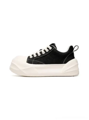 Black platform skate sneakers with geometric white sole shown in side front studio view