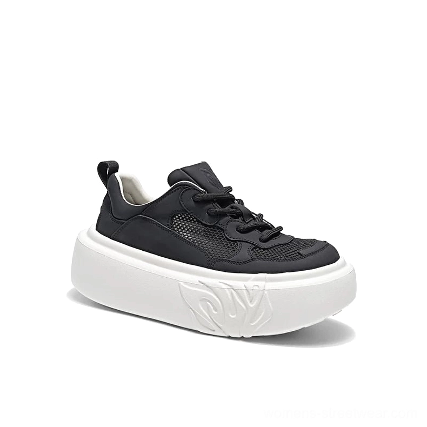Single black platform sneaker with breathable mesh and leather-look upper, white chunky flame embossed outsole, and heel pull tab