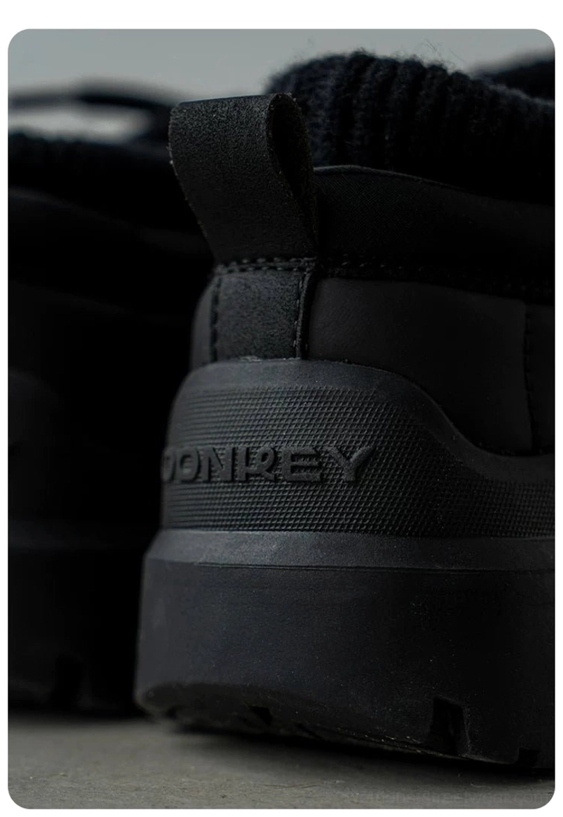 Close-up bottom rear view of black platform sneakers with deep lug traction outsole and rugged everyday streetwear grip