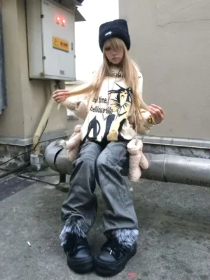 Streetwear model wearing black faux-fur platform snow boots with baggy jeans on an industrial rooftop
