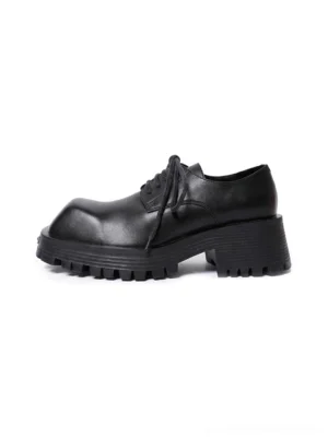 Black leather-look platform Derby shoe shown from the side with a square toe, chunky lug sole, and classic lace-up streetwear design