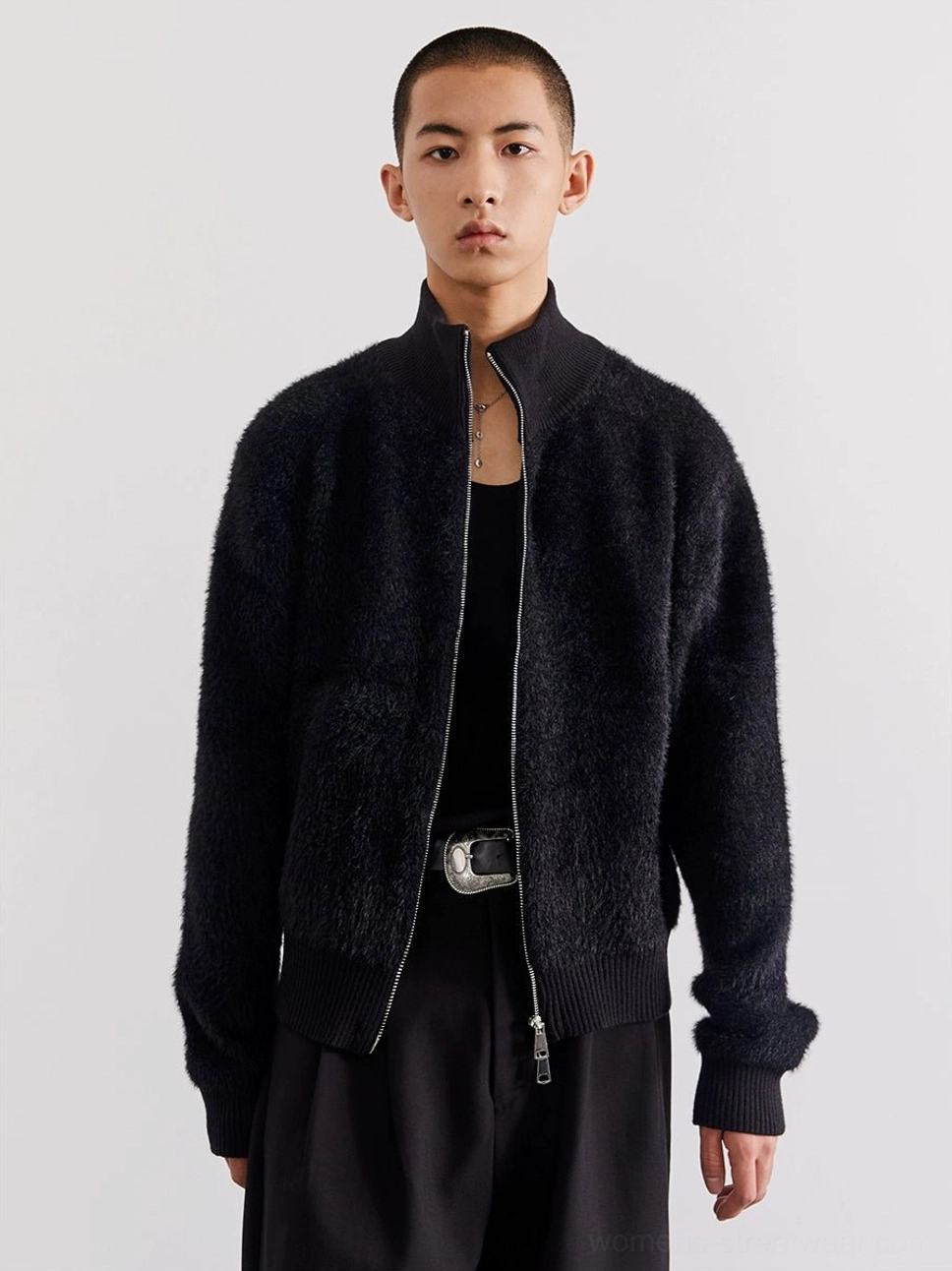 Close front view of black plush zip-up fleece cardigan with silver zipper stand collar and ribbed trims