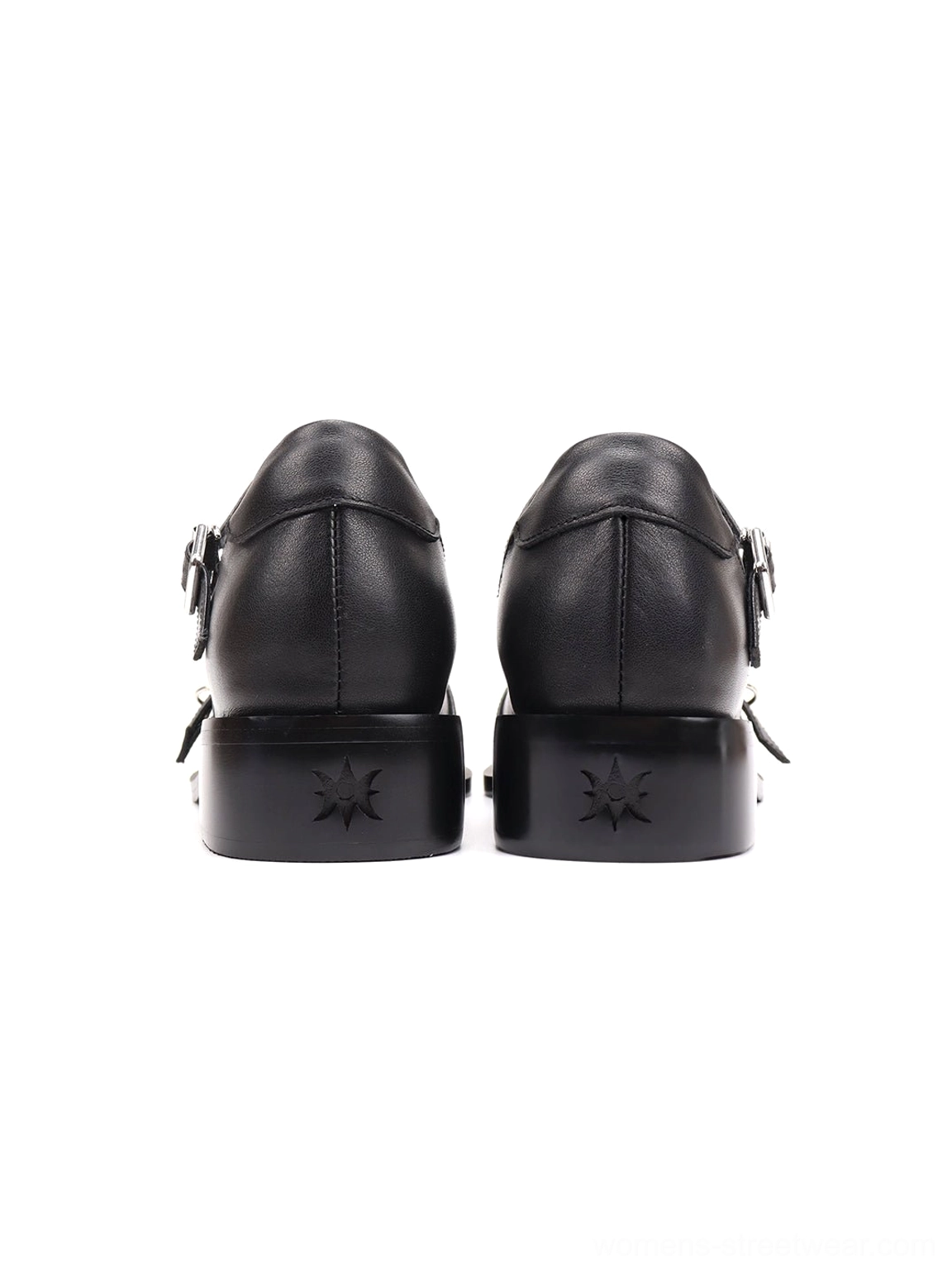 Front flat lay of black pointed Mary Jane flats with multiple silver buckle straps and elongated pointed toes