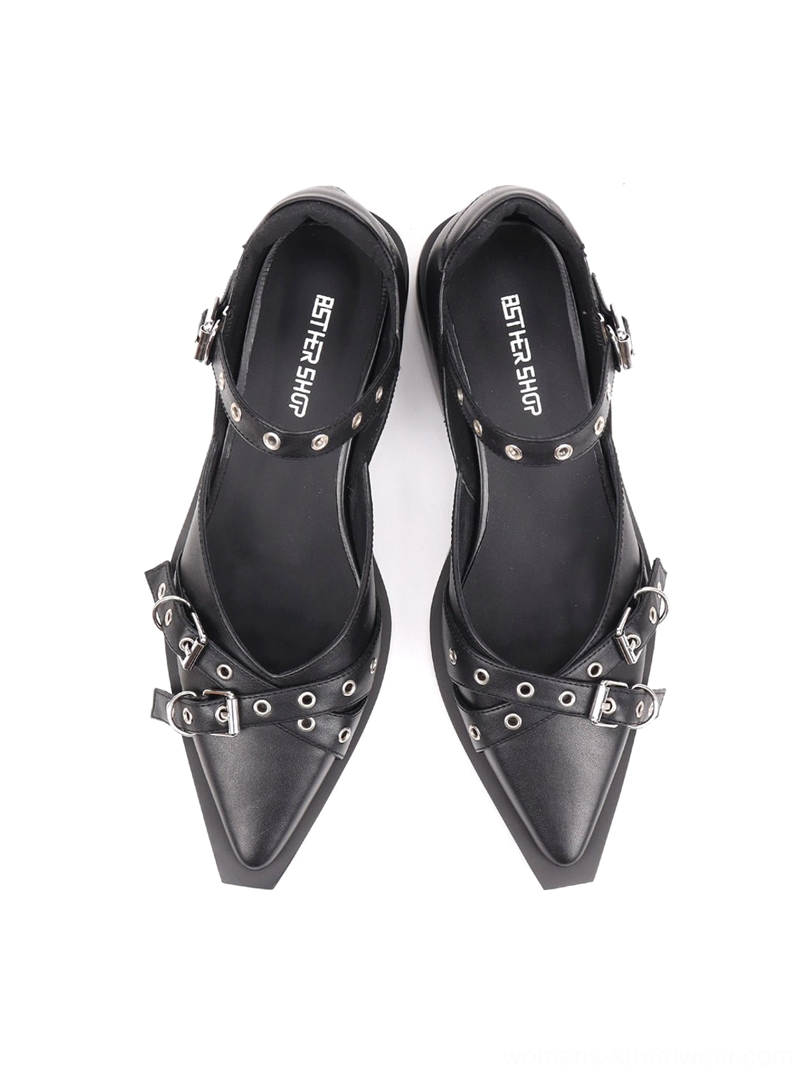 Black pointed Mary Jane flats with open side panels and low square block heel shown on foot from the side