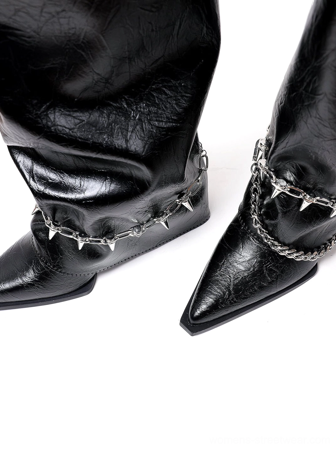 Black pointed-toe chain-trim riding boots designed for women's streetwear outfits with a tall shaft, textured finish, and low wedge heel