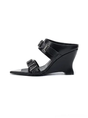 Black pointed-toe triple-buckle wedge sandals shown from the side with open-back slip-on design and sculptural tapered heel