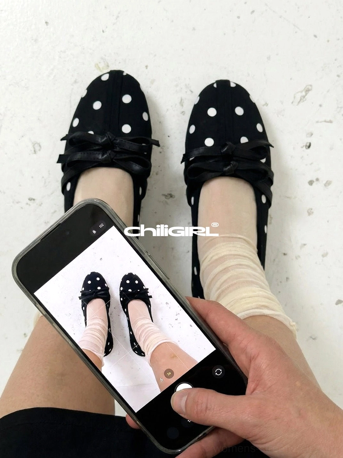 Close-up of black polka dot bow ballet flats worn with beige rolled socks in a casual Korean fashion outfit