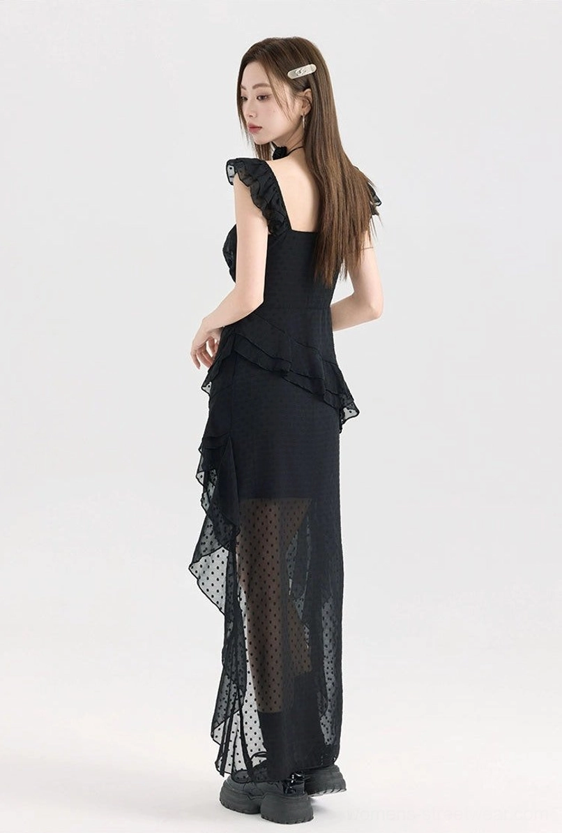 Black polka dot mesh ruffle high-low dress with floral detail, fitted waist, layered skirt, and dramatic asymmetrical sheer overlay