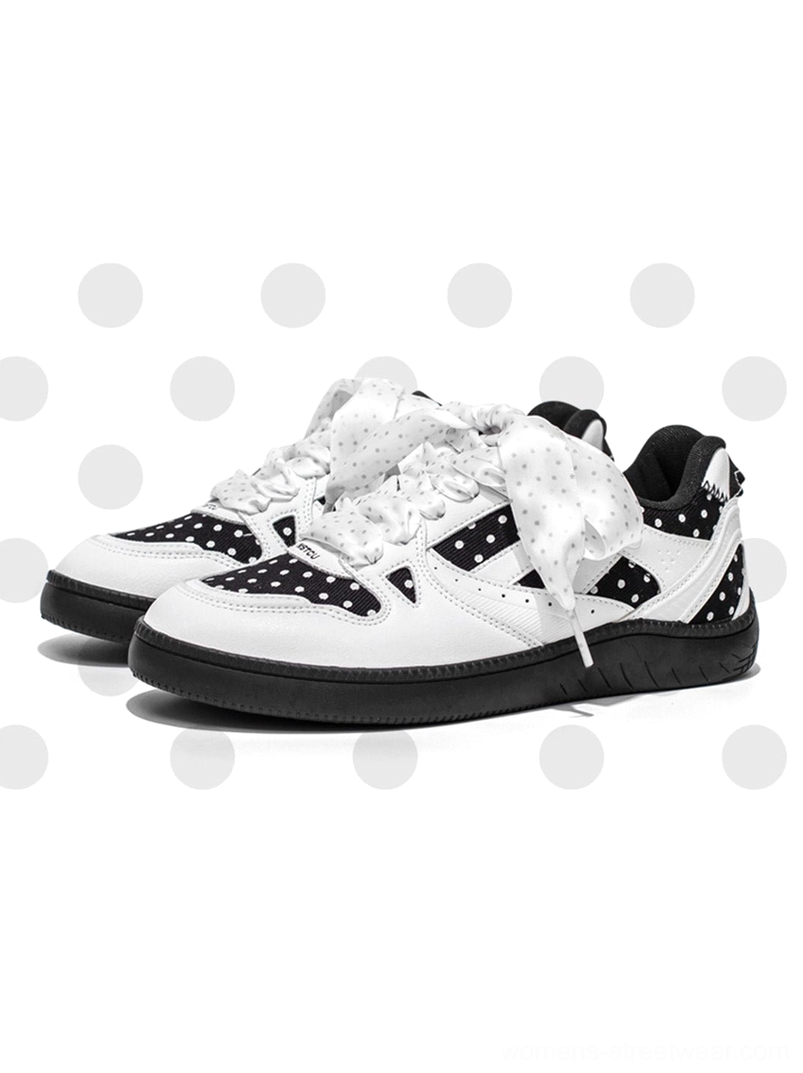 Black polka dot ribbon low top skate sneakers with contrast details and a thick grounded outsole
