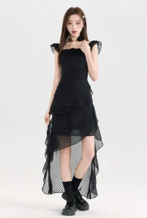 Black polka dot ruffle high-low dress shown from the front with fitted waist, layered ruffle skirt, square neckline, and sheer dotted mesh back train