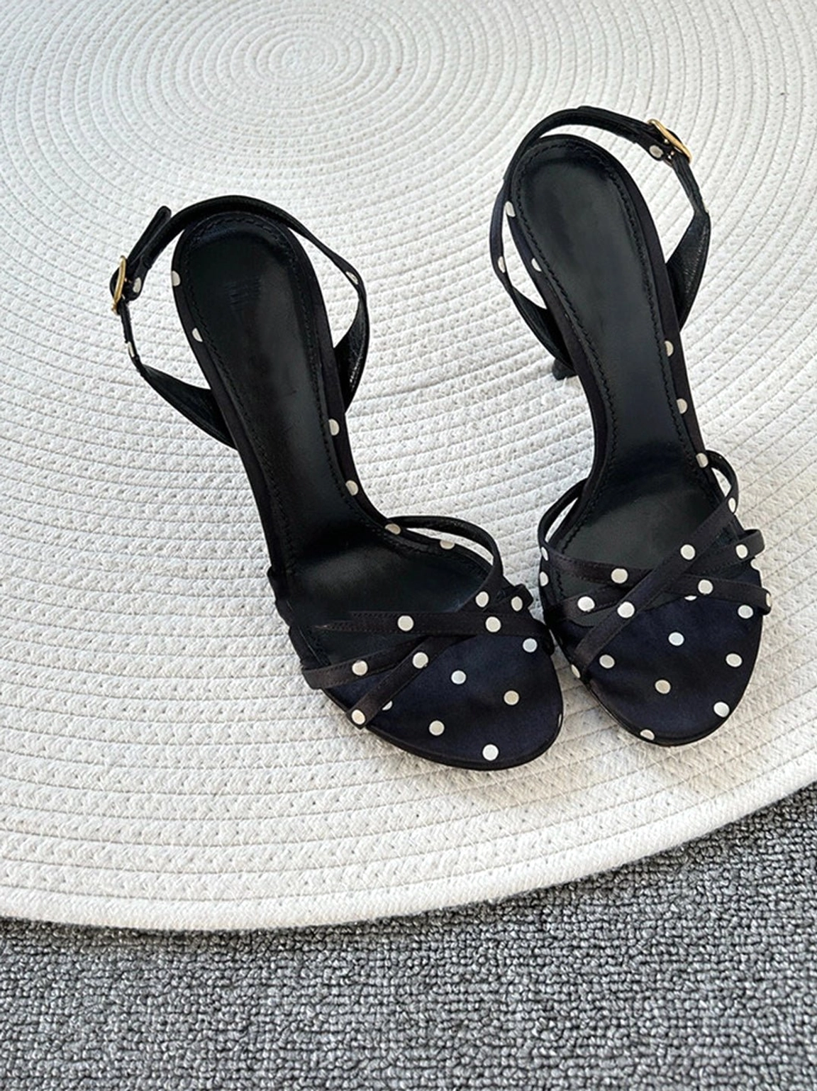 Pair of black polka dot slingback stiletto sandals viewed from above showing the complete patterned exterior and structured silhouette