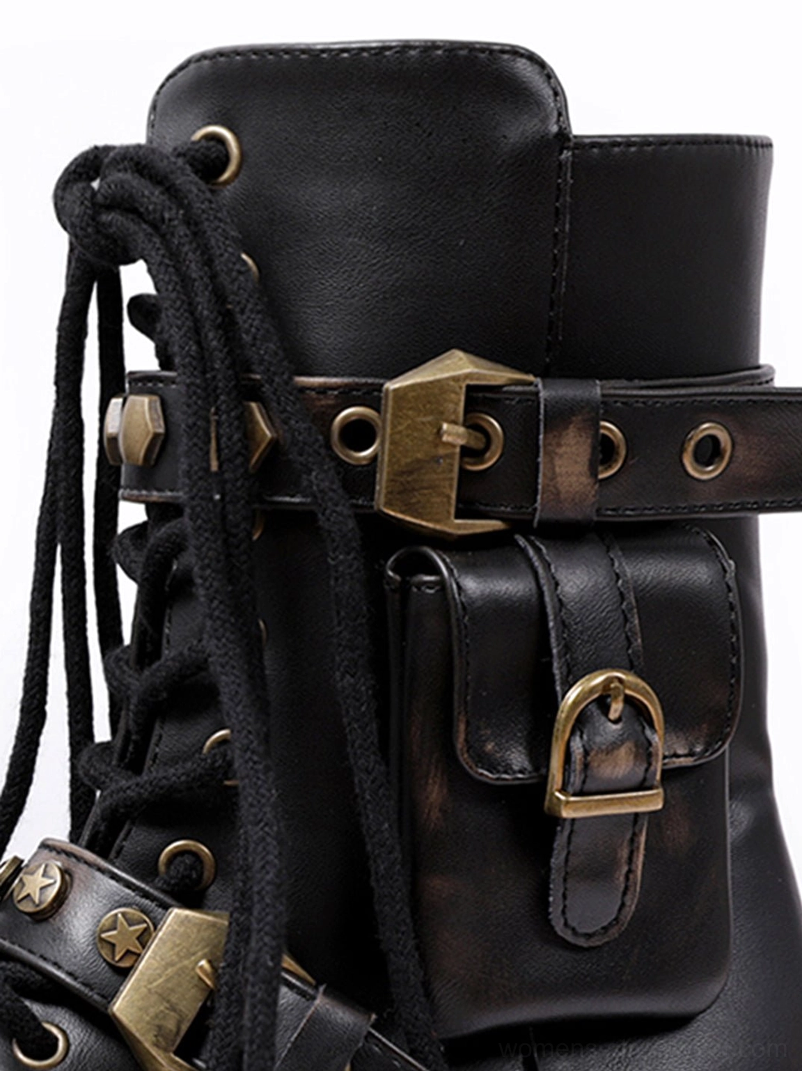 Close-up of black punk ankle boot side showing brass-toned buckles, ankle pocket, buckle closure, and thick black laces