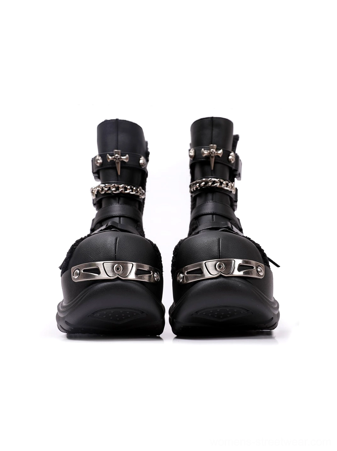 Close-up front view of black punk moto boots with detailed metal toe caps, sturdy platform soles, and neat stitched construction