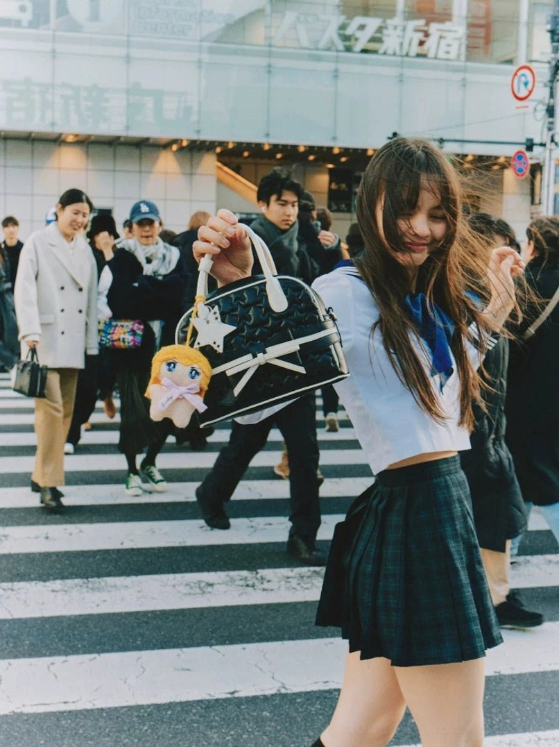 Black quilted bow mini bowling handbag with star detail and plush charm styled for Shibuya-inspired Japanese street fashion