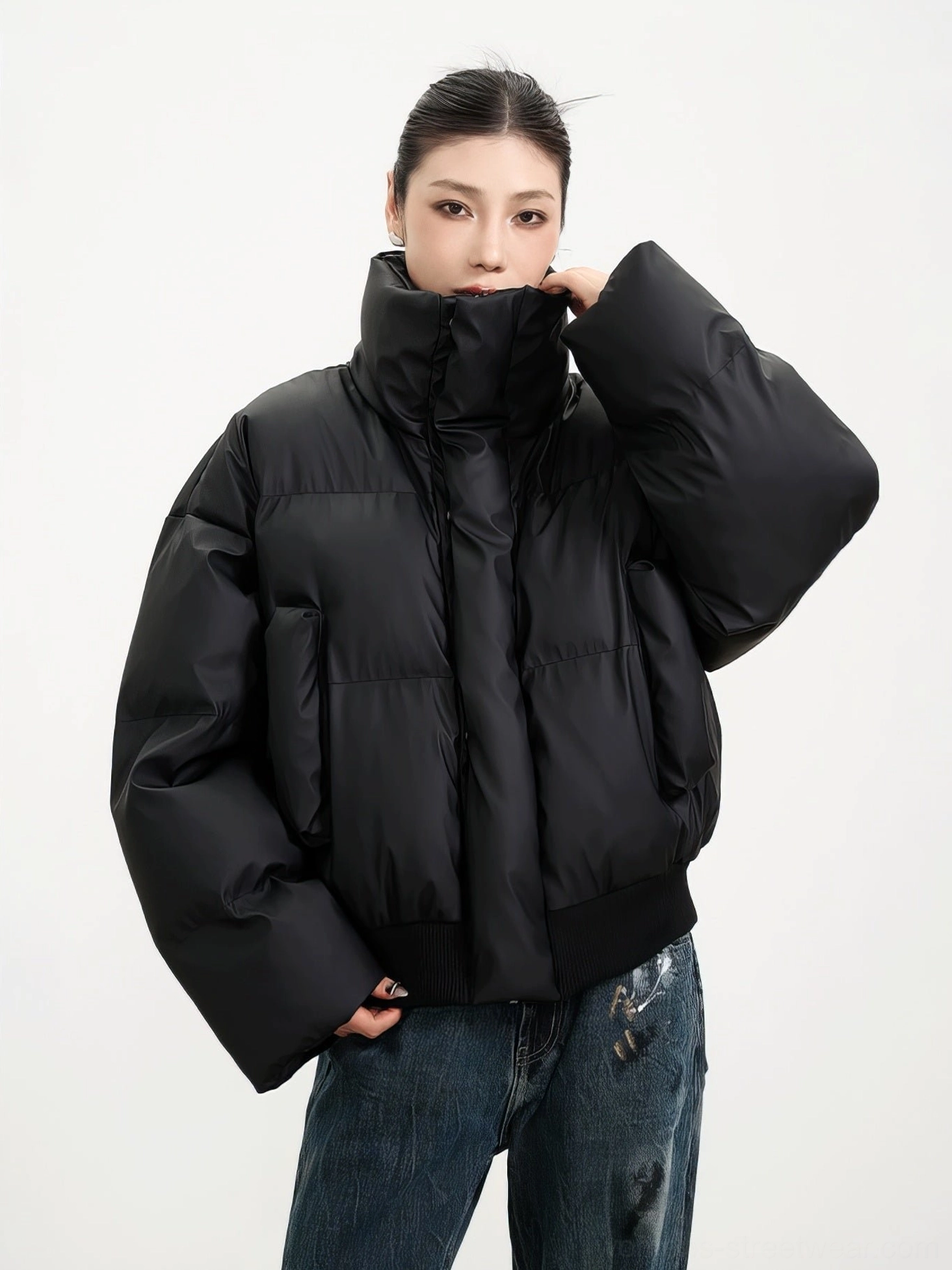 Black quilted cropped winter puffer jacket with high stand collar styled with blue distressed denim