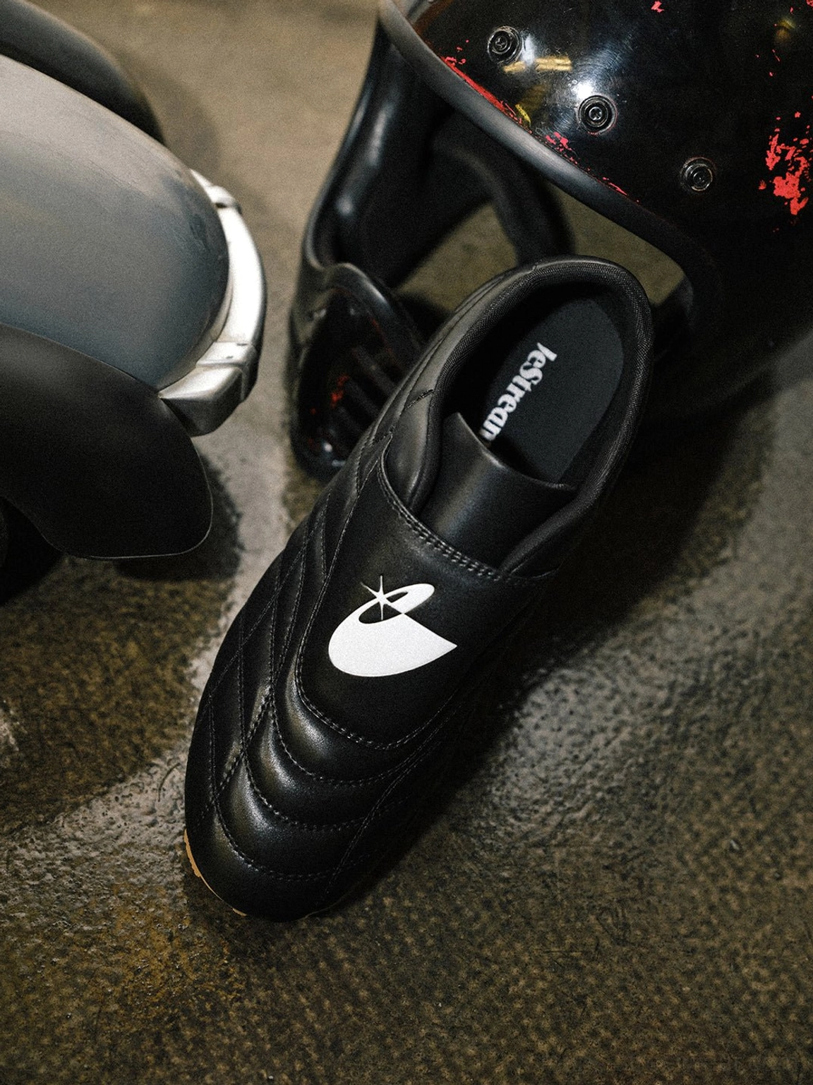Black quilted soccer sneakers with slim silhouette and casual football-inspired design for men and women