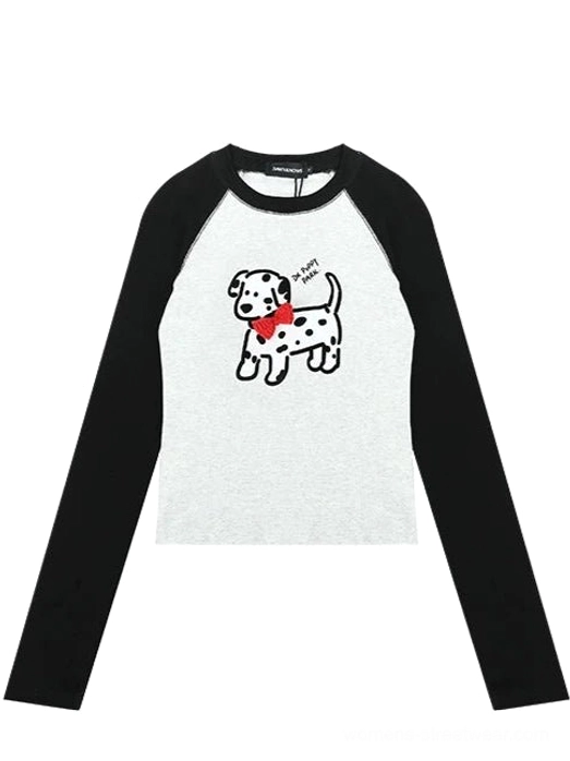 Flat lay display of a black raglan sleeve cartoon Dalmatian graphic cropped long sleeve T-shirt with crew neck and heather grey body