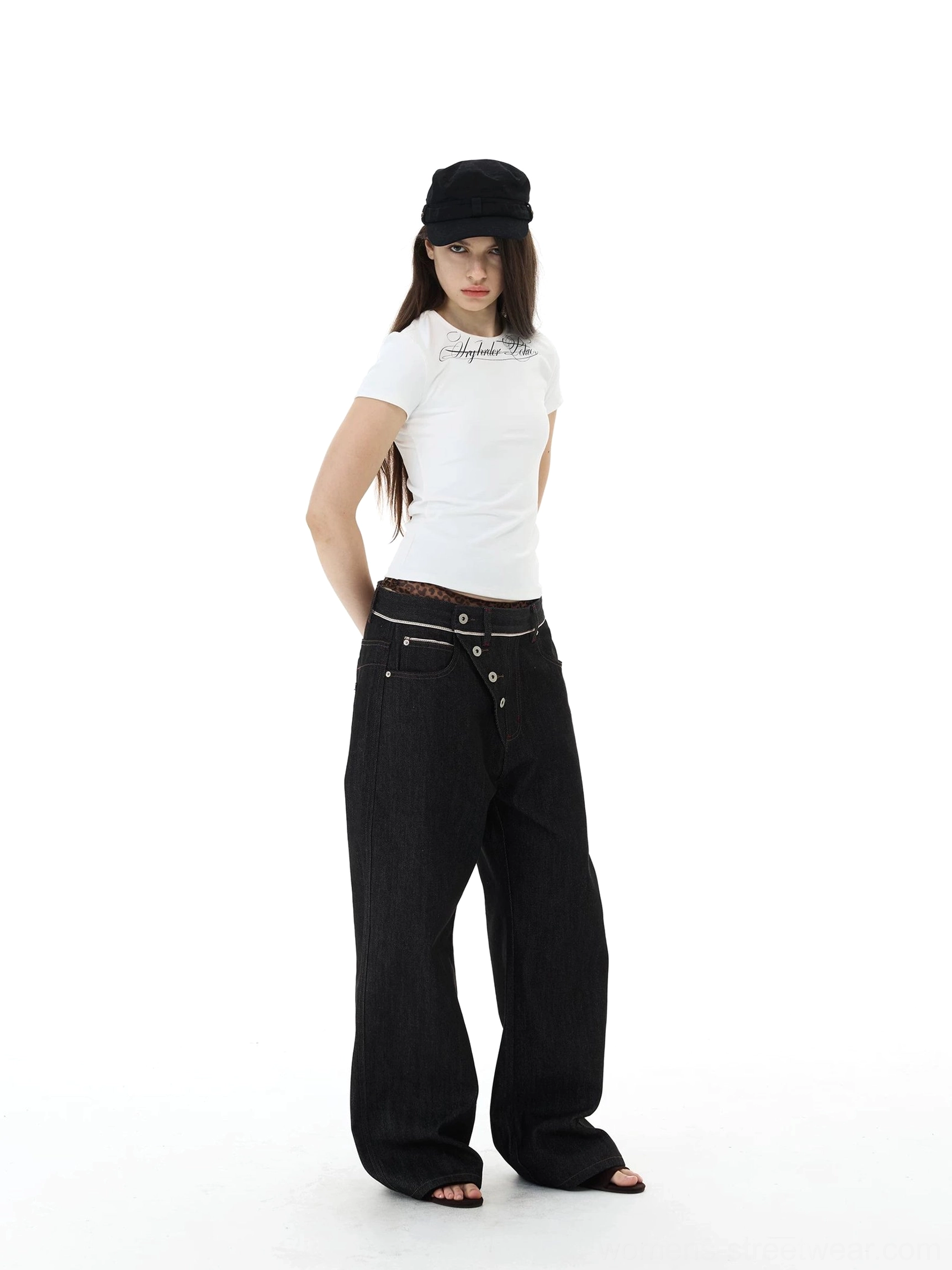 Front view of black raw denim wide-leg jeans with asymmetric button waist and oversized baggy streetwear silhouette