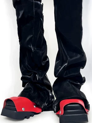 Black and red peep-toe platform derby shoes worn with glossy black flared leather pants front view