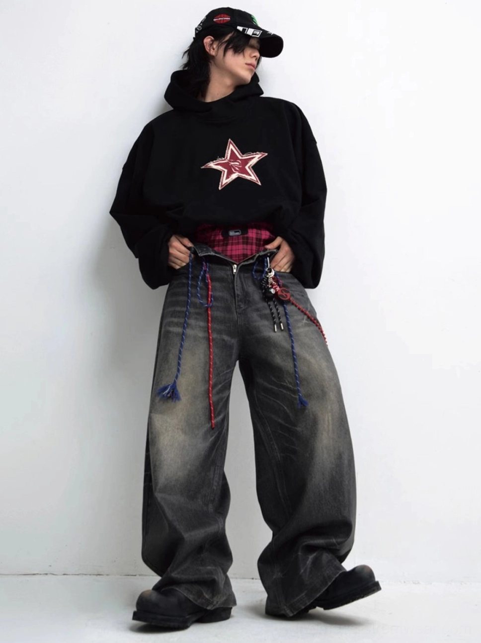 Side front view of black red star graphic hoodie with relaxed fit and urban streetwear accessories
