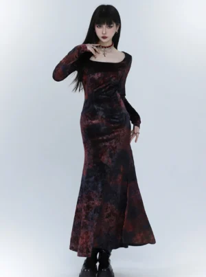 Three-quarter side view of a black red velvet fishtail dress showing the soft velvet texture, fitted waist, long sleeves, and elegant floor-length evening silhouette