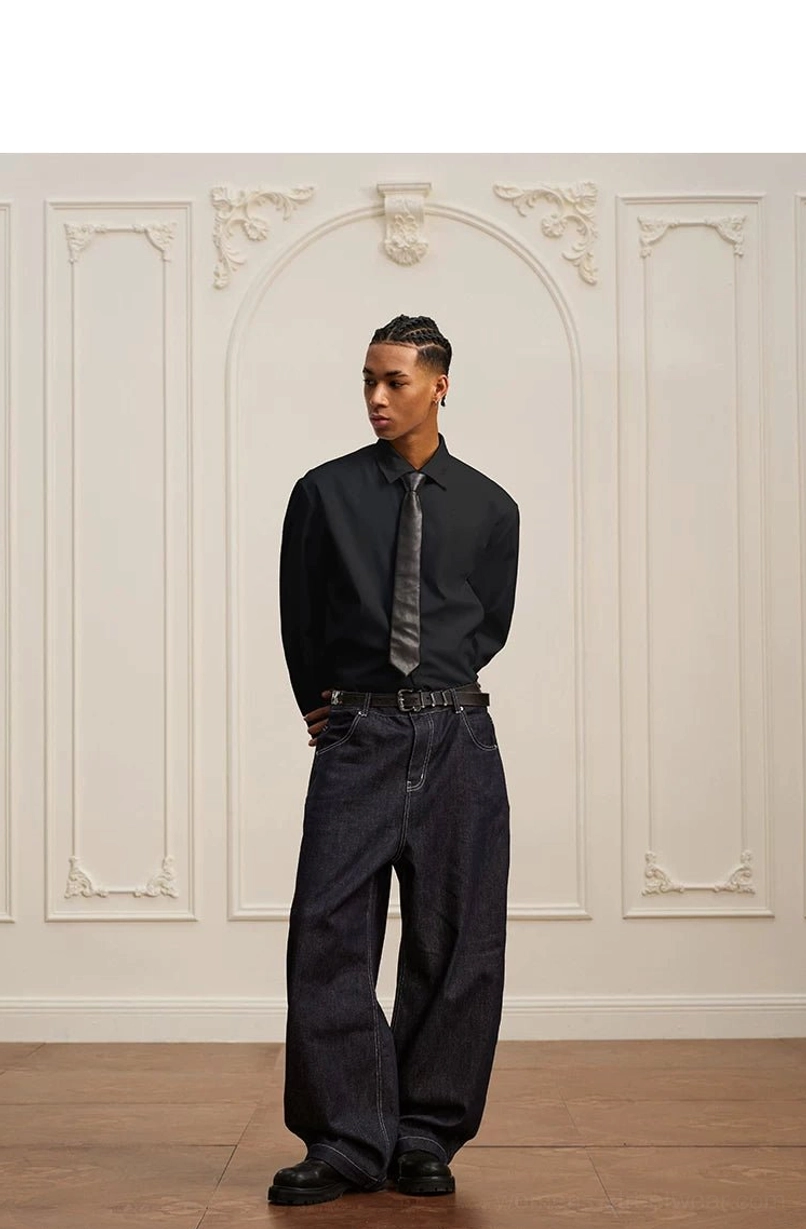Black relaxed formal long-sleeve shirt with grey necktie and dark wide-leg jeans in modern streetwear styling