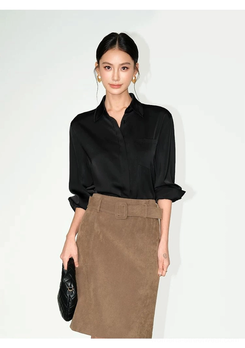Black relaxed satin pocket shirt with rolled cuffs styled with a tan midi skirt for a minimalist office outfit