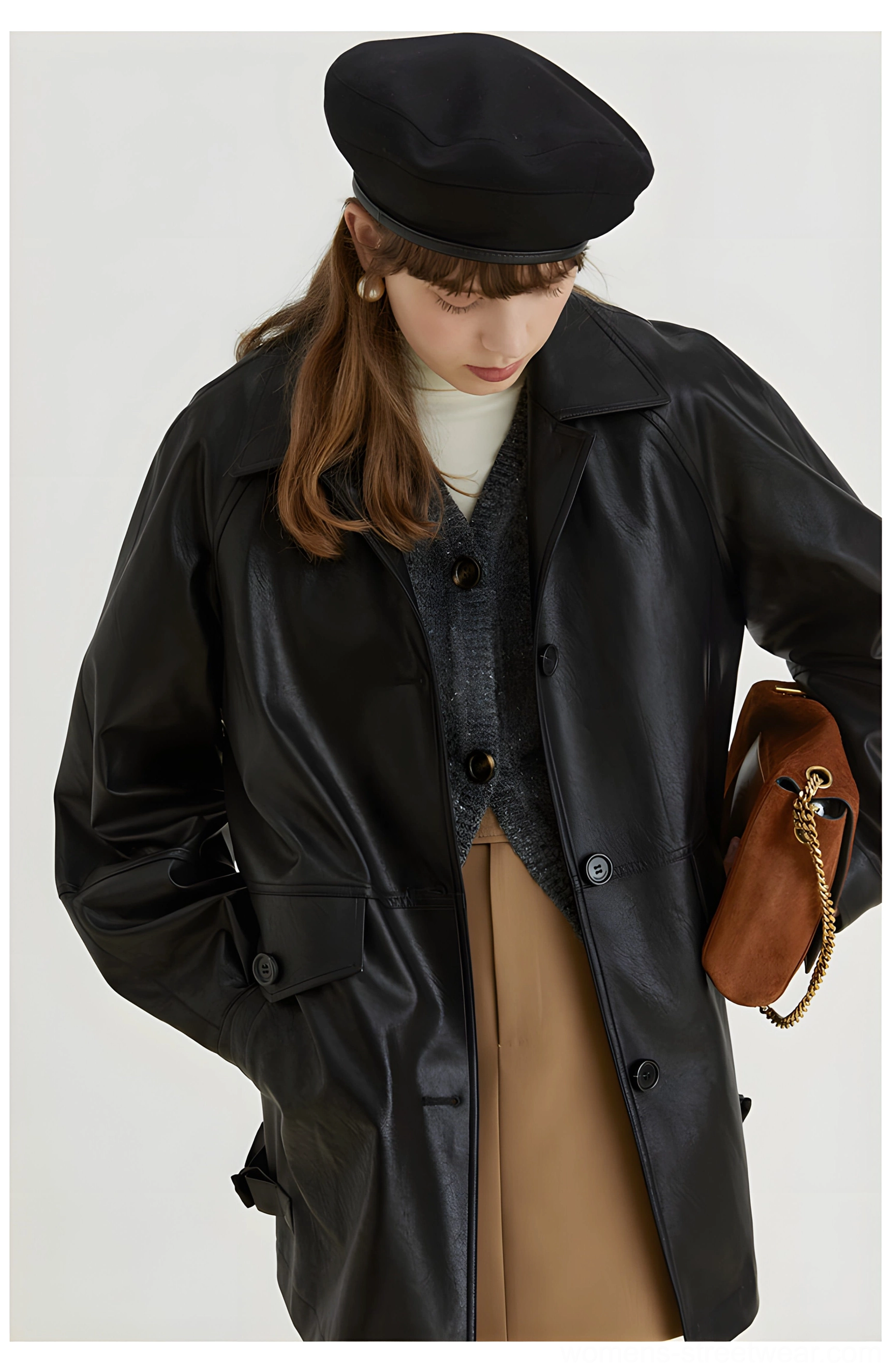 Three quarter front view of black retro PU leather moto jacket featuring utility flap pockets relaxed sleeves and glossy texture