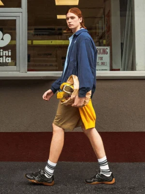 Black retro runner sneakers styled with a casual streetwear outfit outside a convenience store in a Seoul-inspired urban setting