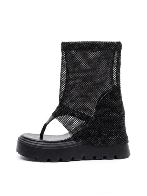 Black rhinestone mesh knee-high thong platform sandal boots with chunky lug sole on white background
