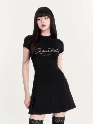 Black rhinestone quote pleated tennis dress front view with fitted short sleeves and flared mini skirt styled with lace thigh high stockings and black heels