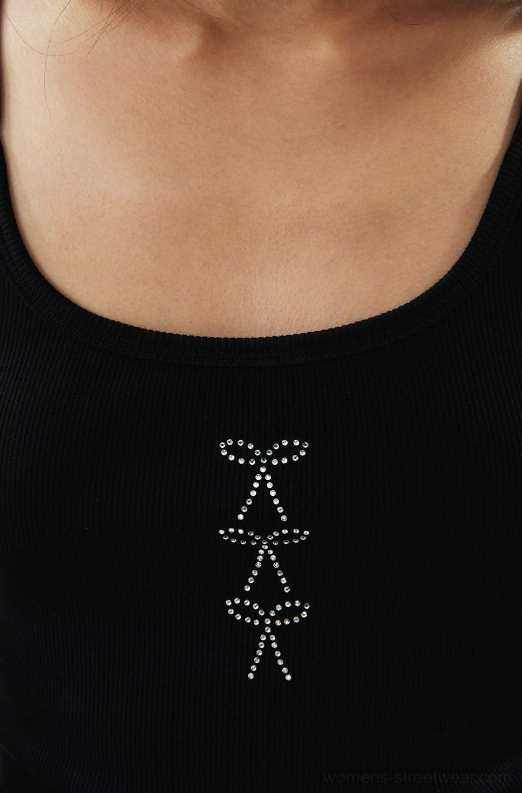 Close-up of black ribbed cami tank top with square neckline and layered rhinestone bow embellishments