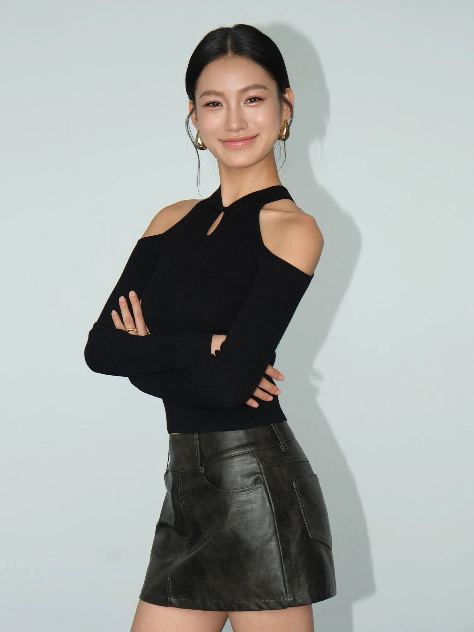 Black ribbed cold-shoulder keyhole knit top product detail with slim sleeves and modern cropped streetwear fit