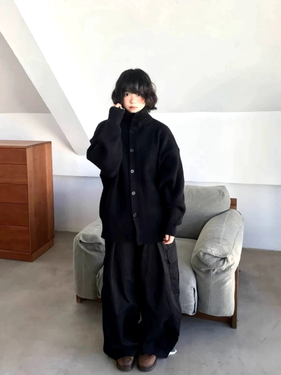 Black oversized ribbed knit cardigan sweater styled with wide-leg trousers for a minimalist Seoul streetwear outfit