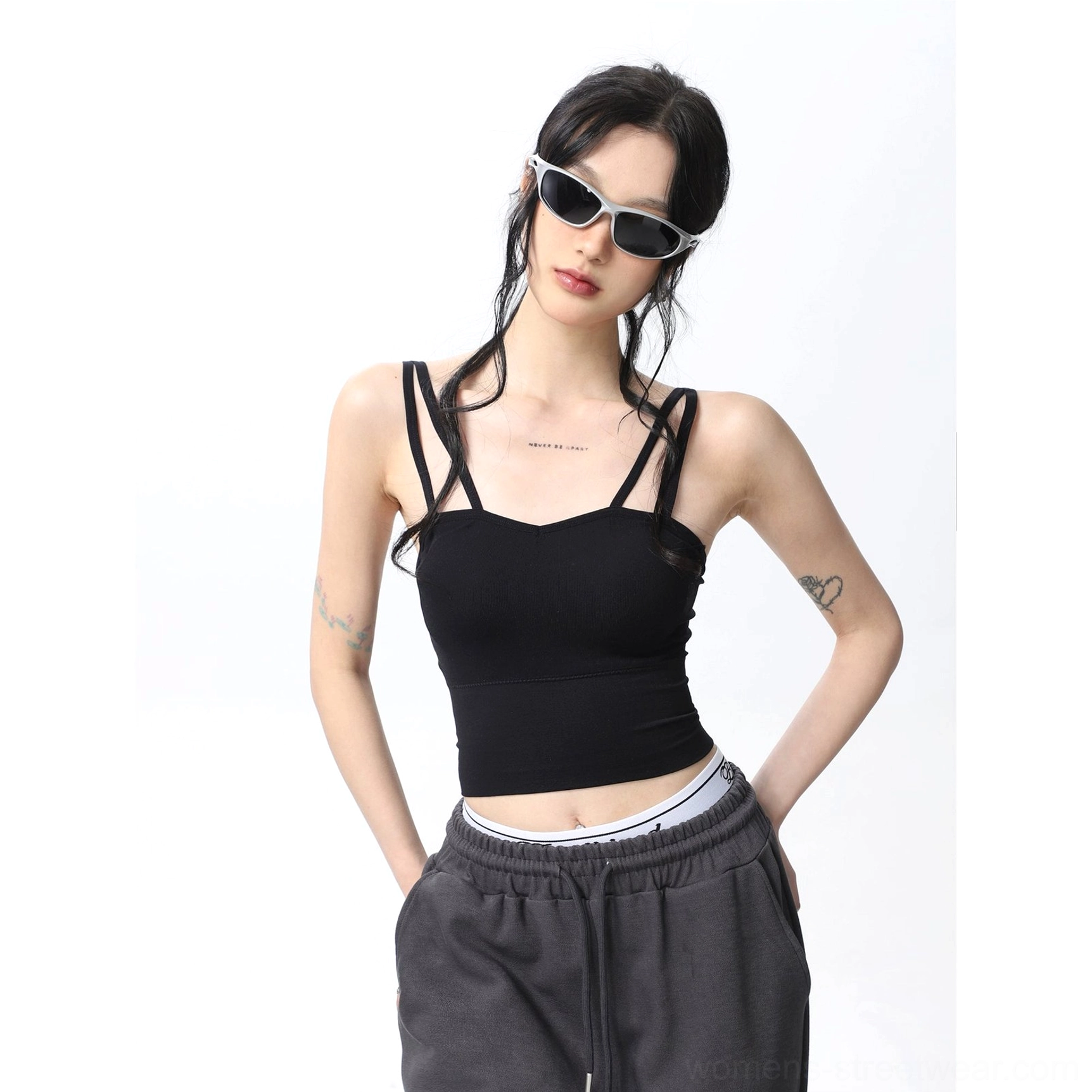 Black ribbed padded double spaghetti strap cropped camisole tank top shown with dark gray sweatpants in a minimalist Korean fashion look