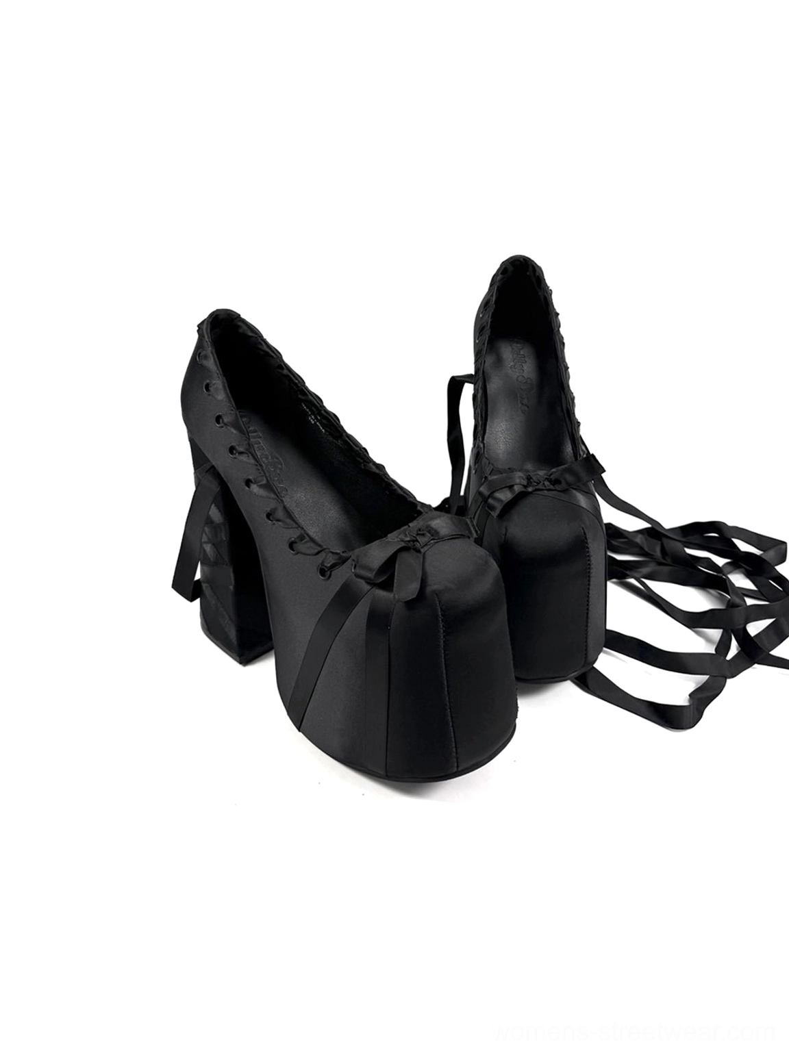 Front three-quarter view of black ribbon lace platform pumps with satin ties, square platform toes, lace-up vamps, and chunky heels
