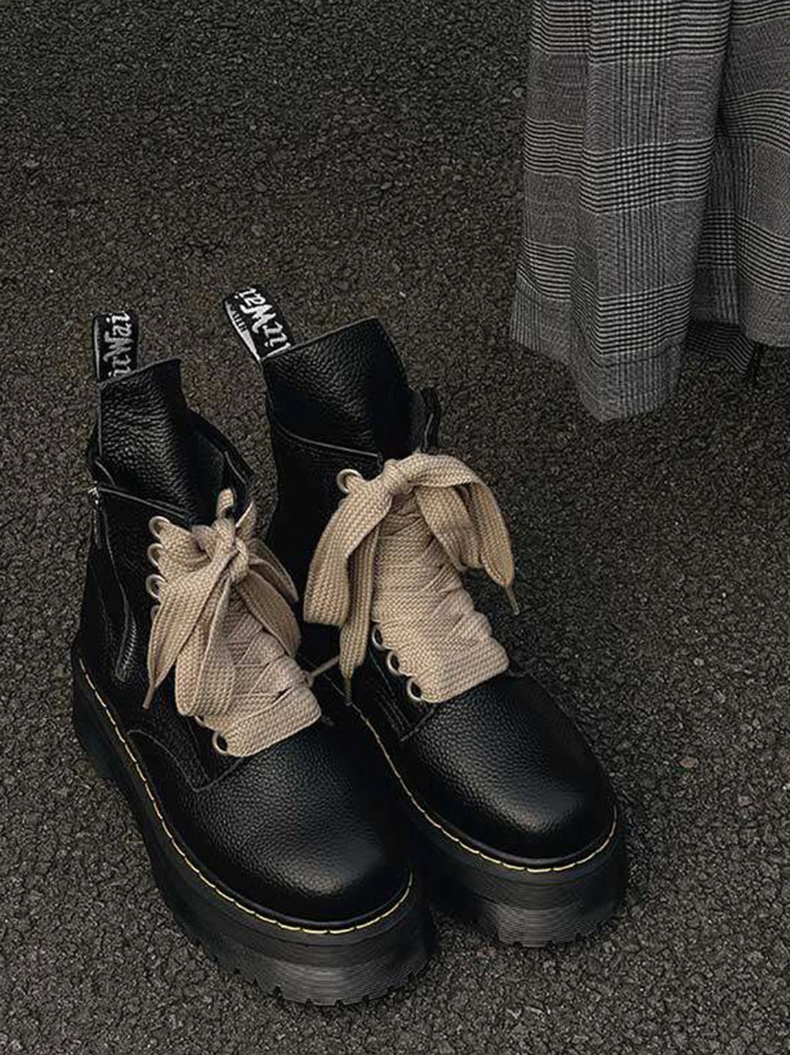 Black ribbon-laced chunky side-zip platform combat boots with cream laces and lugged soles for women's streetwear styling