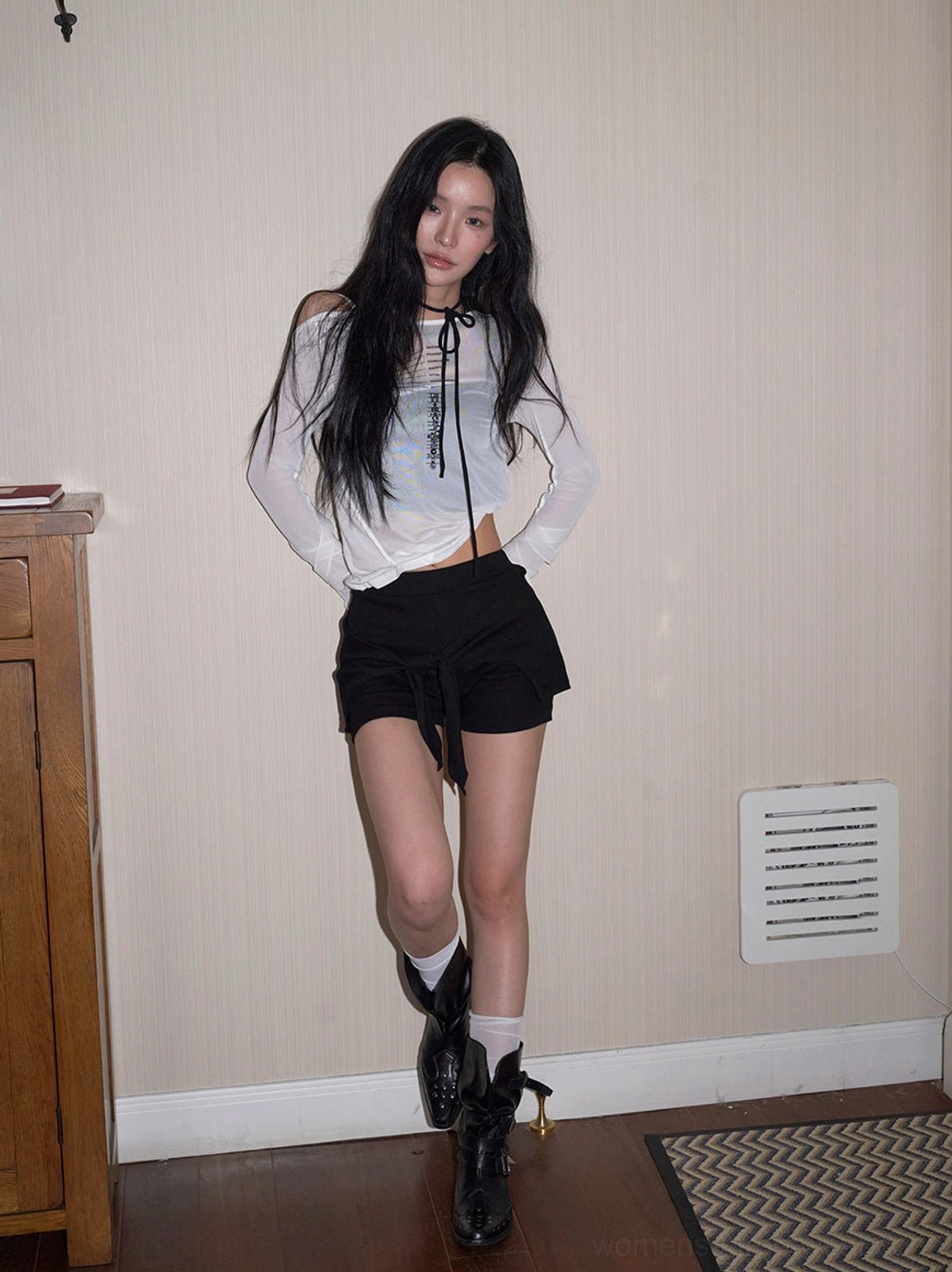 Black rivet buckle ankle boots styled with cropped lace-up top black drawstring shorts and white crew socks